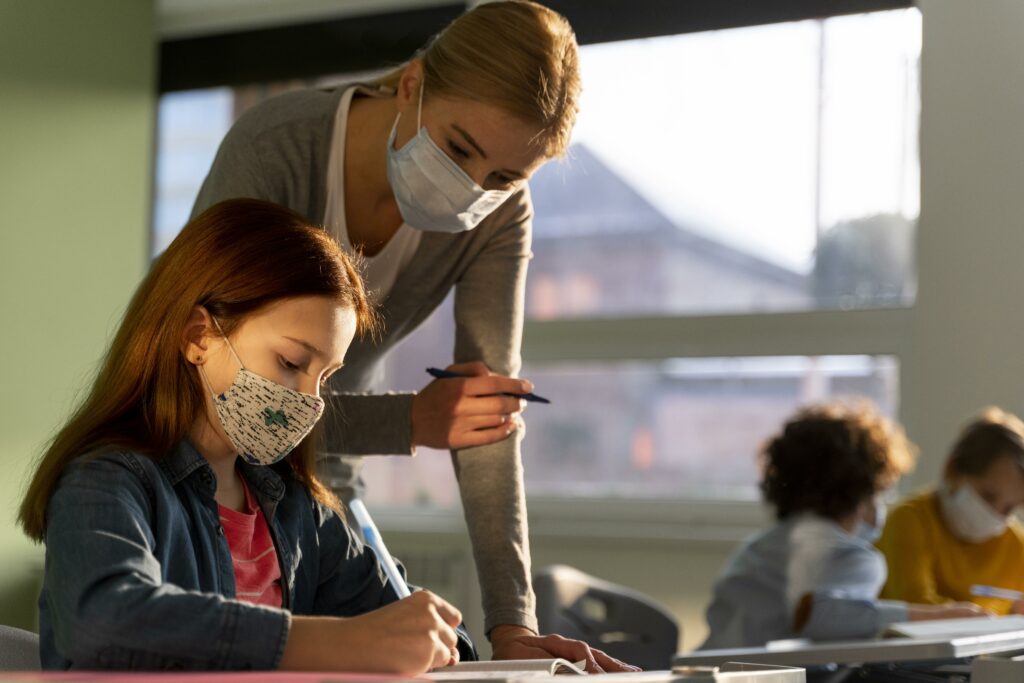 Girl with her teacher during pandemic