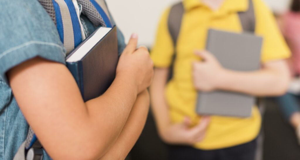 Kids holding their subject books