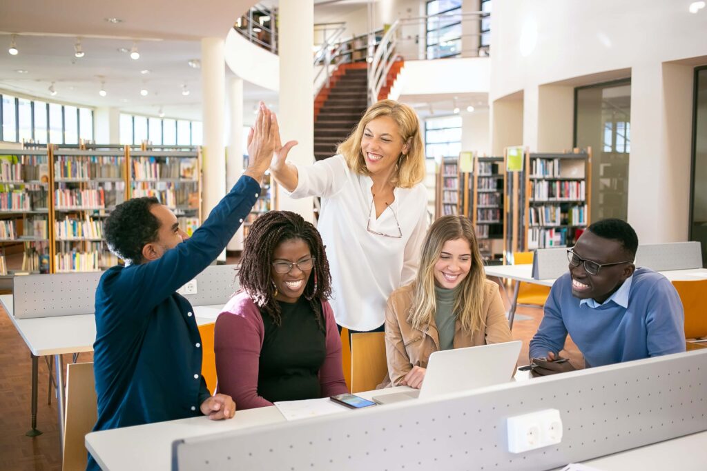 Teacher high fiving her students