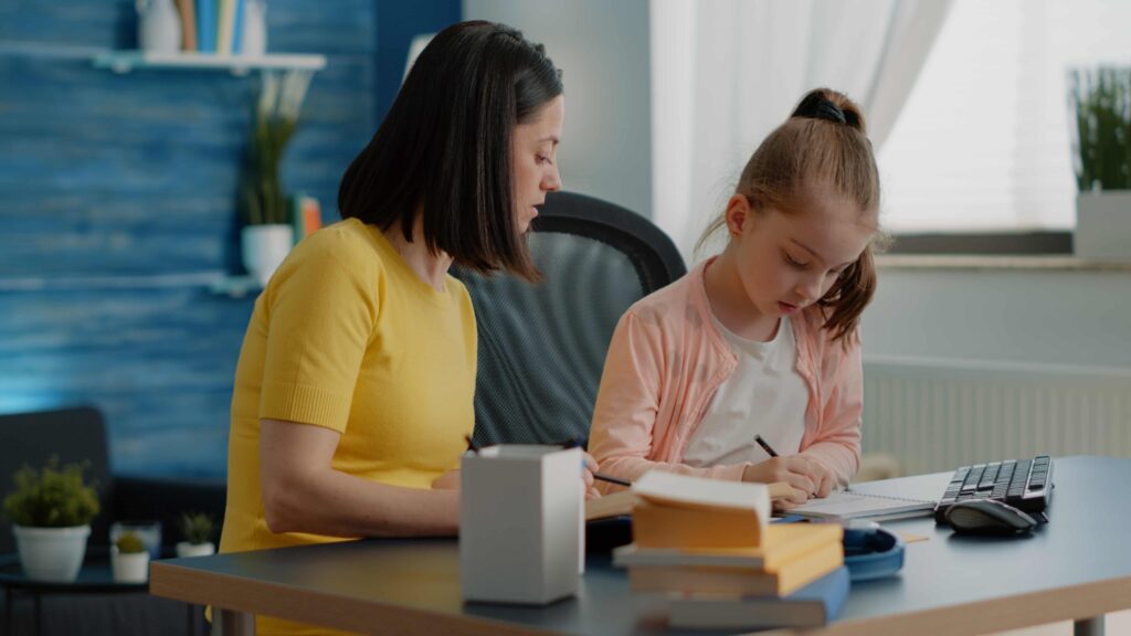 Tutor explaining a lesson to little girl