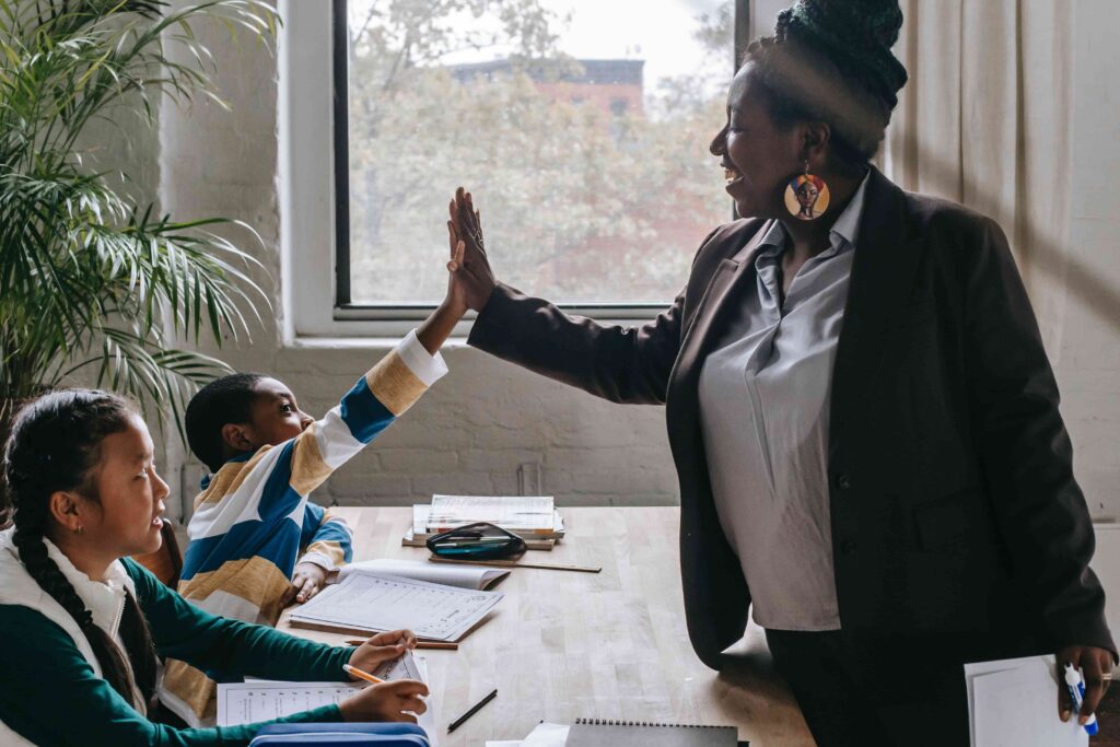 Tutor high-fiving the student