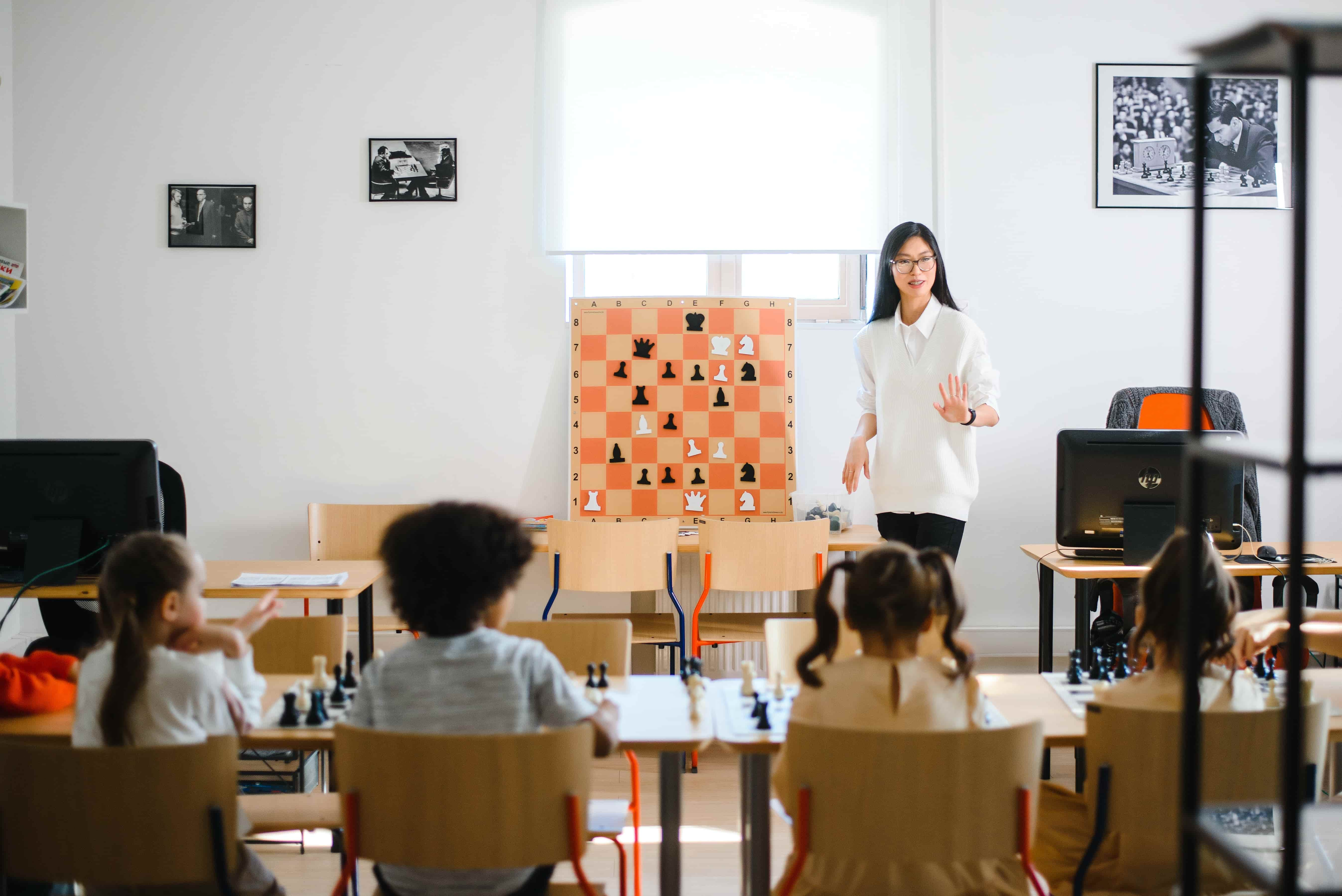 Teacher explains Chess concepts to her students